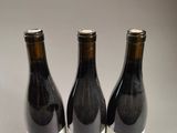 three bottles of wine sitting next to each other on a table