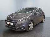 the grey car is parked in a large room with a black floor