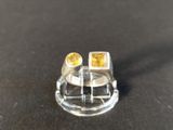 a close up of a ring with two yellow stones on it