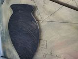 a black vase sitting on top of a piece of paper