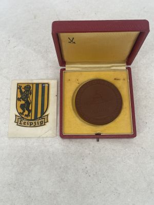 an image of a medal in a red box with a gold medal in it
