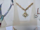 many different types of jewelry displayed on a table