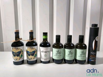 several bottles of wine are lined up on a table