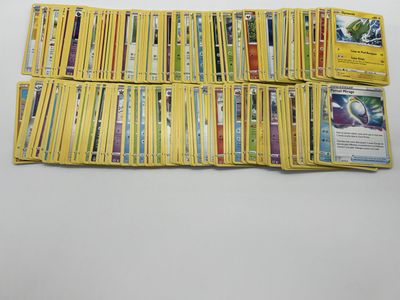 a pile of pokemon cards sitting on top of a table