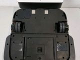 the bottom of a black and white device with four wheels