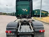a green truck that is parked in the parking lot
