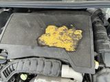 a yellow substance on the engine of a car