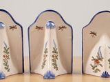 three salt and pepper shakers sitting on a table