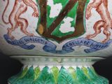a large vase with a coat of arms and a lion on it