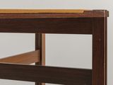 close up view of the top of a wooden table with a piece of wood on it