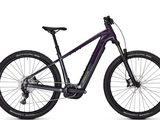 a purple and black mountain bike on a white background