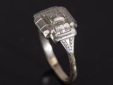 a close up of a ring with a diamond on it
