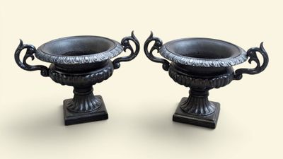 two black vases sitting on top of each other