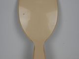 beige plastic hand held mirror on a white surface