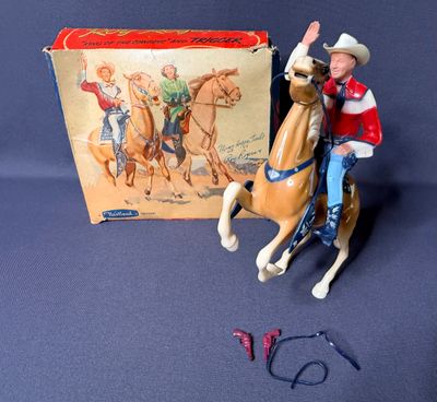 a figurine of a man riding a horse next to a box