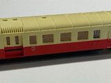 a toy train on a white surface with a white background