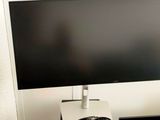 a computer monitor sitting on top of a black desk