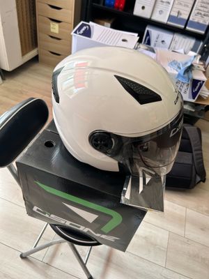 a helmet sitting on top of a chair in a room