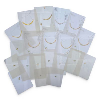 a lot of white cards with gold chains on them
