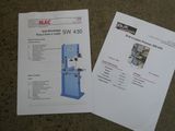 two manuals on a table with a machine and a sheet of paper