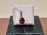 sterling silver and garnetite pendant on a marble block