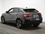 the rear end of a grey audi qx parked in a room