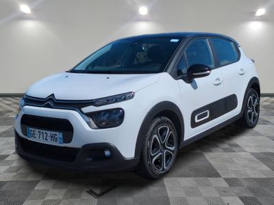 a white citrole parked in a room with a checkered floor