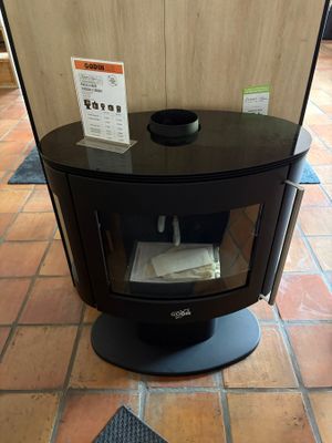 a black stove sitting on a tiled floor in a room