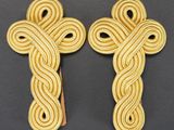 a pair of wooden crosses with a knot on each of them