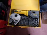 a yellow box with tools in it sitting on the floor