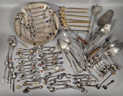 a lot of silver spoons and silverware on the table