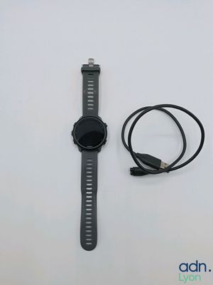 a watch and a charger sitting on a table