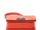 a small red bag with a metal buckle on the front