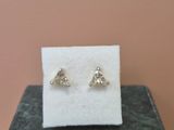 a close up of a pair of earrings sitting on top of a box