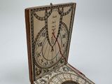 a clock inside of a box on a white surface