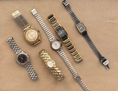 a lot of watches that are sitting on a table