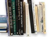 a lot of books that are on a shelf together
