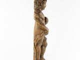 a wooden statue of a boy holding a bird on a white background