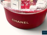 a snow globe with a chanel perfume bottle inside of it