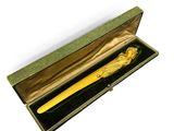gold plated pen in a box with a green velvet lining