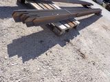 several pieces of steel sit on top of a pile of wood