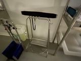a bathroom with a toilet, sink, and ladder