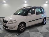 a picture of a small white car parked in a garage