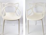 four white chairs sitting next to each other on top of a white floor