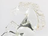 a glass horse statue that is standing on its hind legs