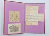 an open book with a drawing of a boat on it
