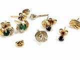 many different types of earrings on a white surface