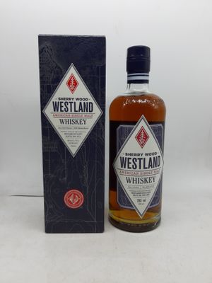 une bouteille de whisky Westland posée à côté d'une boîte sur une table