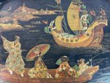 many people in a boat with umbrellas on the water