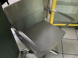 a metal chair that is sitting in front of a glass door